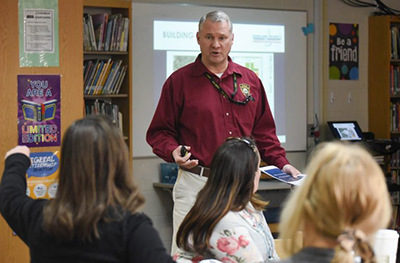 School Readiness Liaison Scott Lambertson facilitates an armed assailant tabletop exercise at a school.